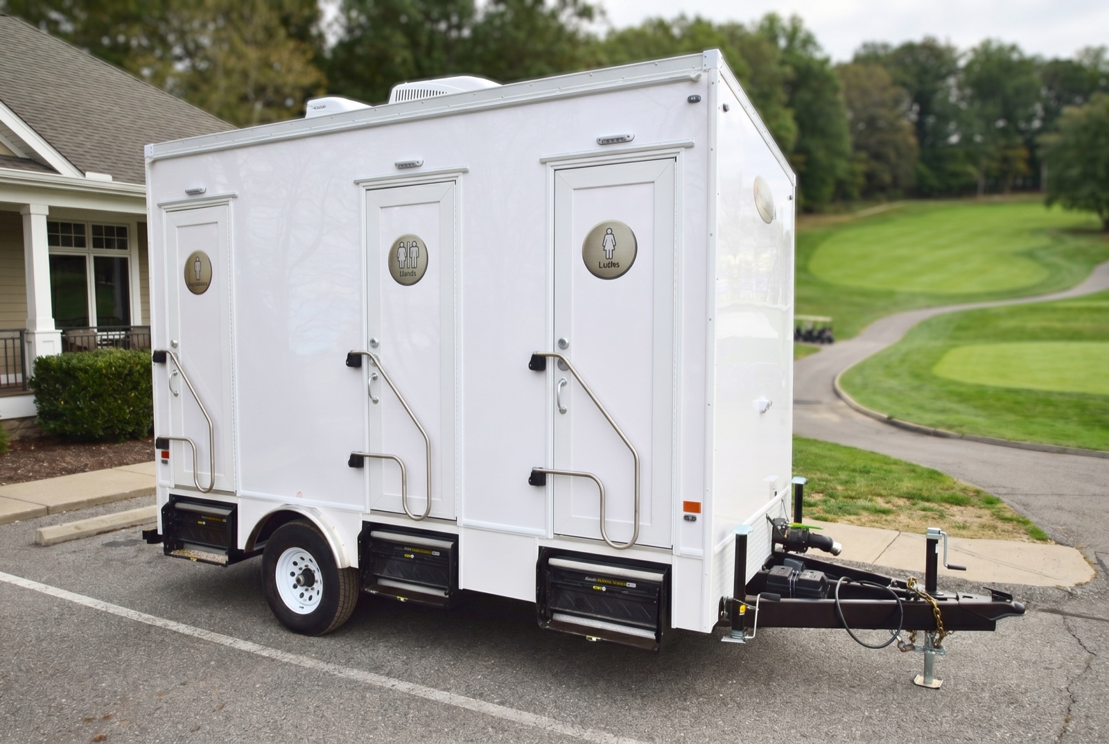 Washroom trailer beside a golf-course clubhouse